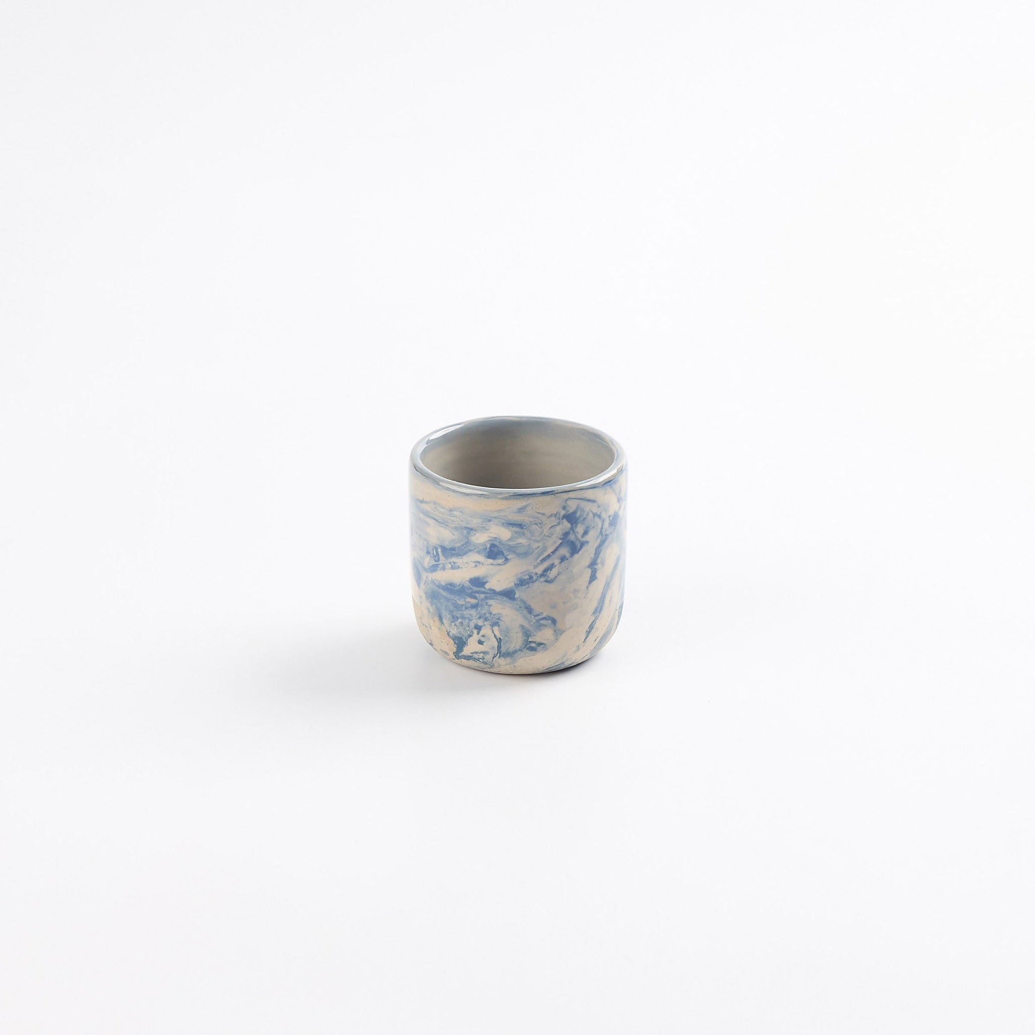 Ceramic espresso cup with marbled abstract design in cobalt blue and white by Palinopsia