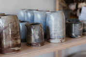 Shelf with marbled ceramics displayed in Newcastle's handmade ceramics store 