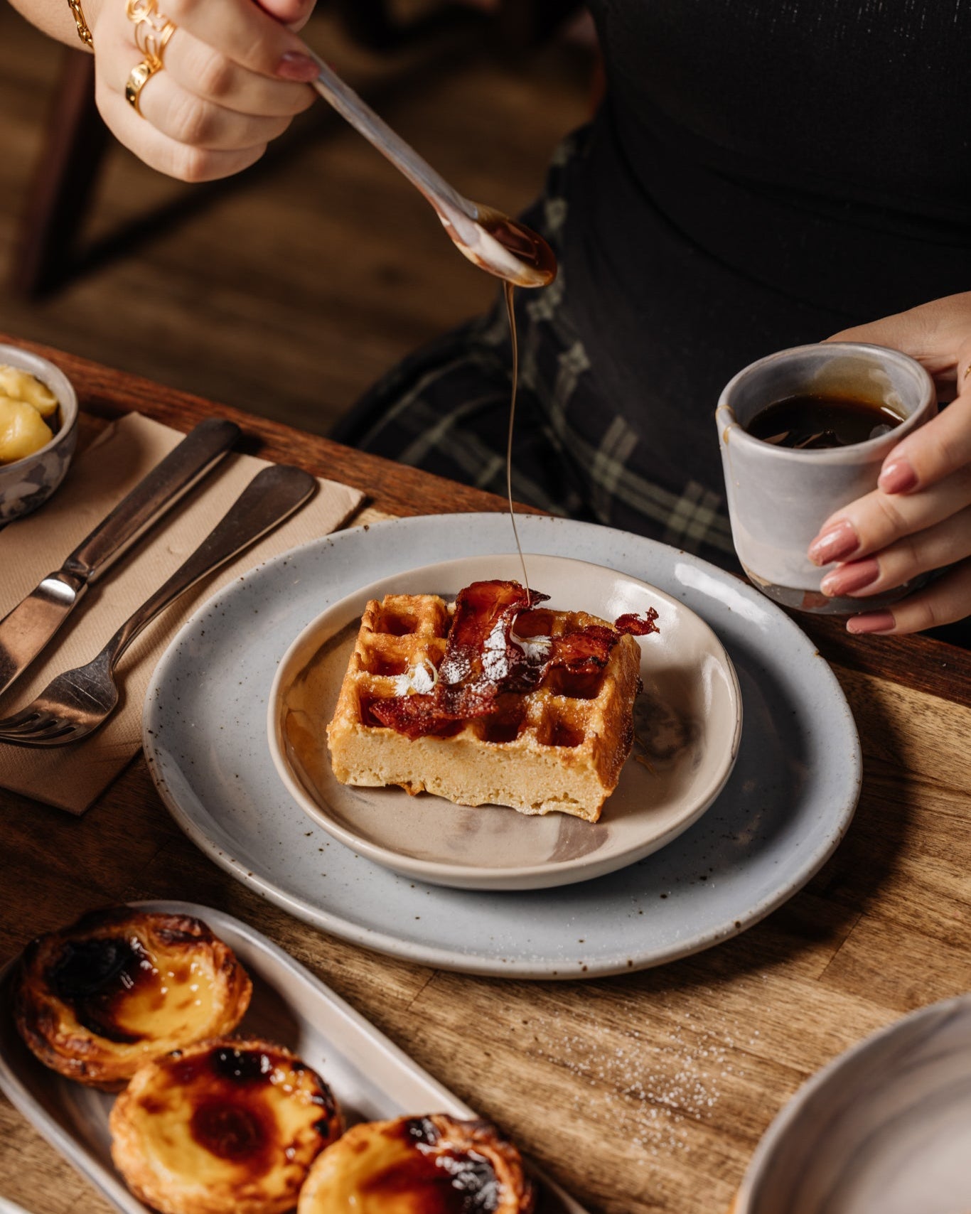 Brunch at Autumn Rooms Cafe serving golden waffles with bacon on speckled ceramic Maya Lunch plate by Palinopsia Ceramics