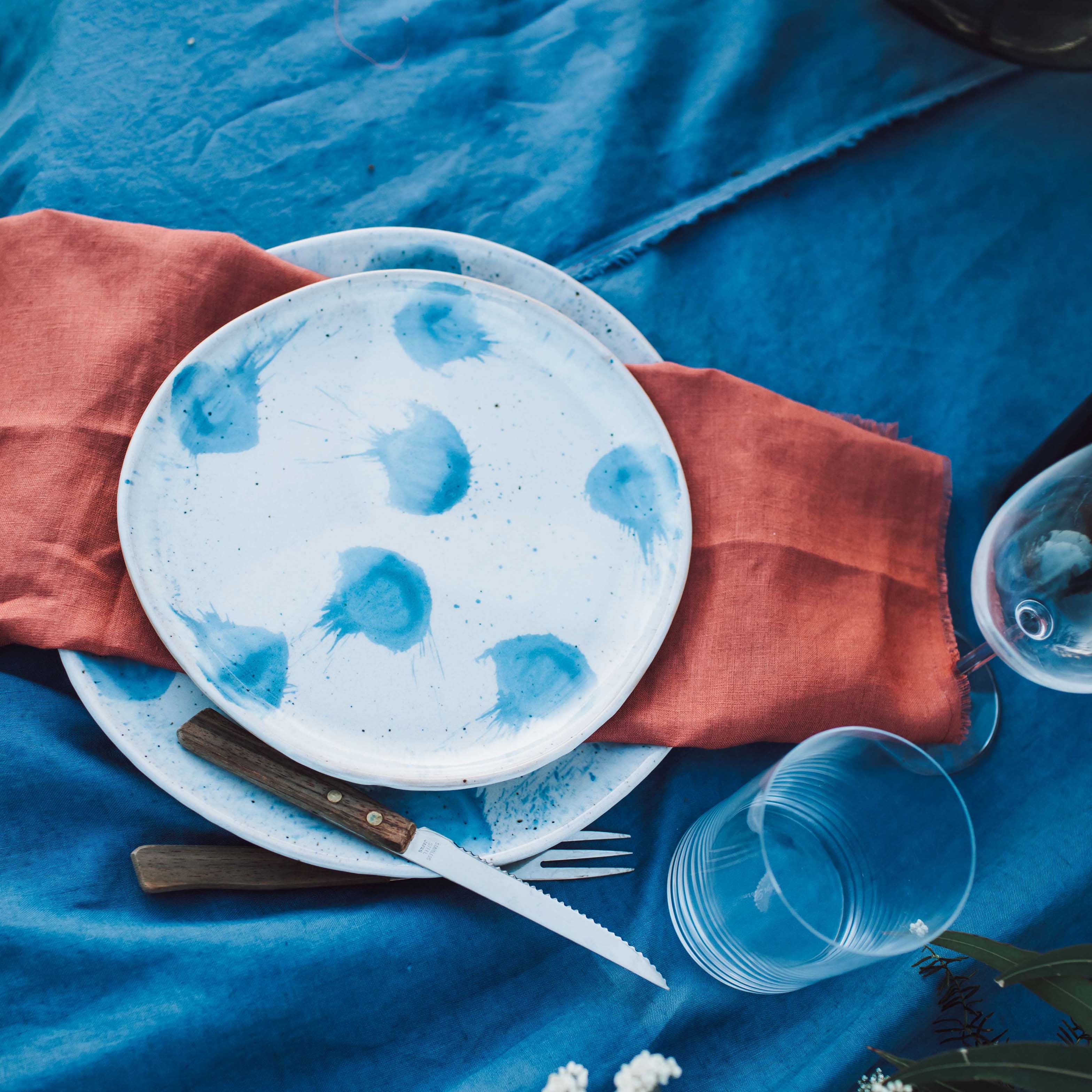 Blue and white plates on a blue linen tablecloth 