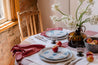 Country style table setting with apples, wild flowers and a blue and white dinner set by Palinopsia Ceramics 