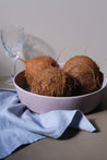 Handmade low salad and fruit bowl by Palinopsia Ceramics with coconuts and Australian made pure linen table napkins