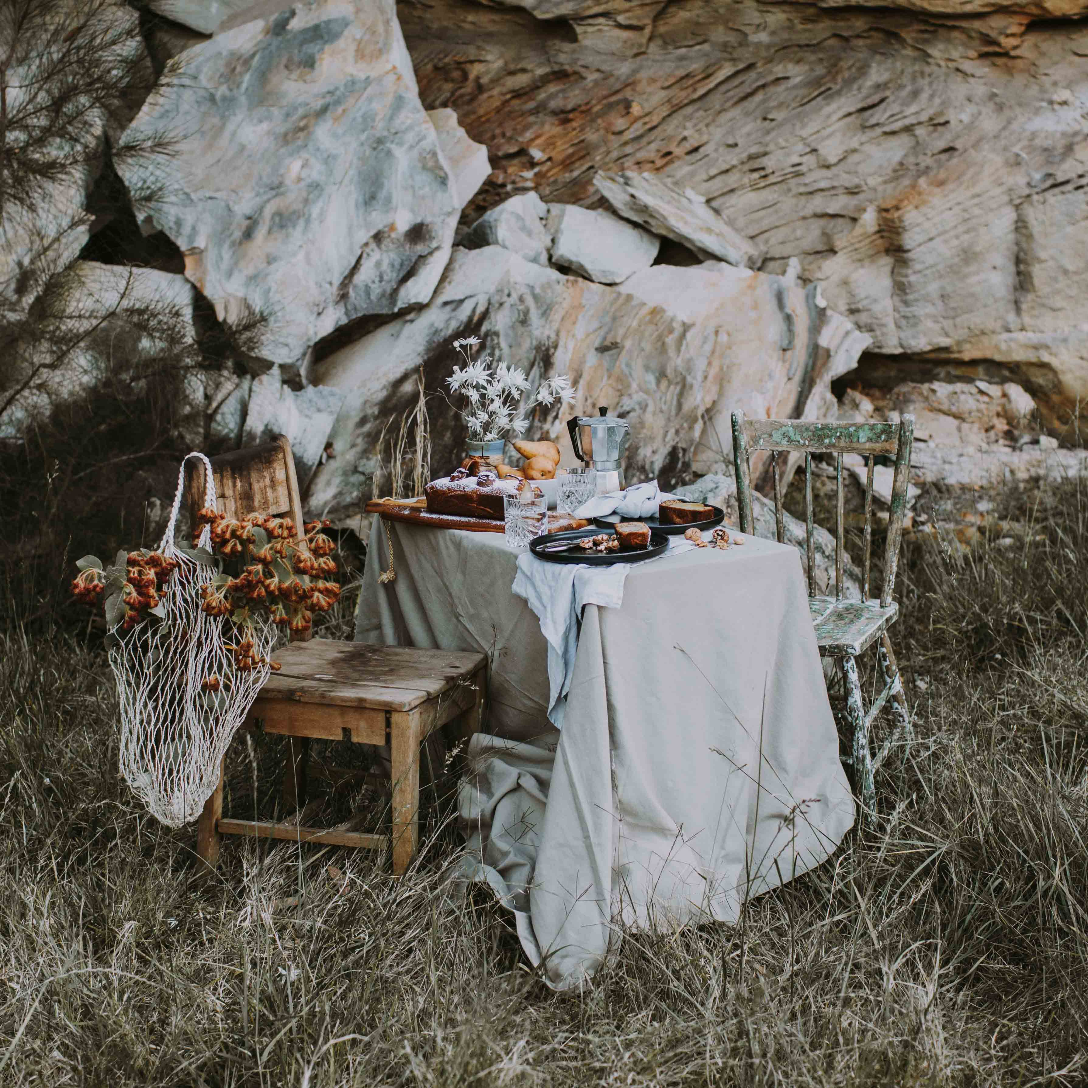 Australian outdoor dining with native wild flowers, homemade gluten free cake and Palinopsia ceramics handmade Sabe dinner set in black, grey and blue 