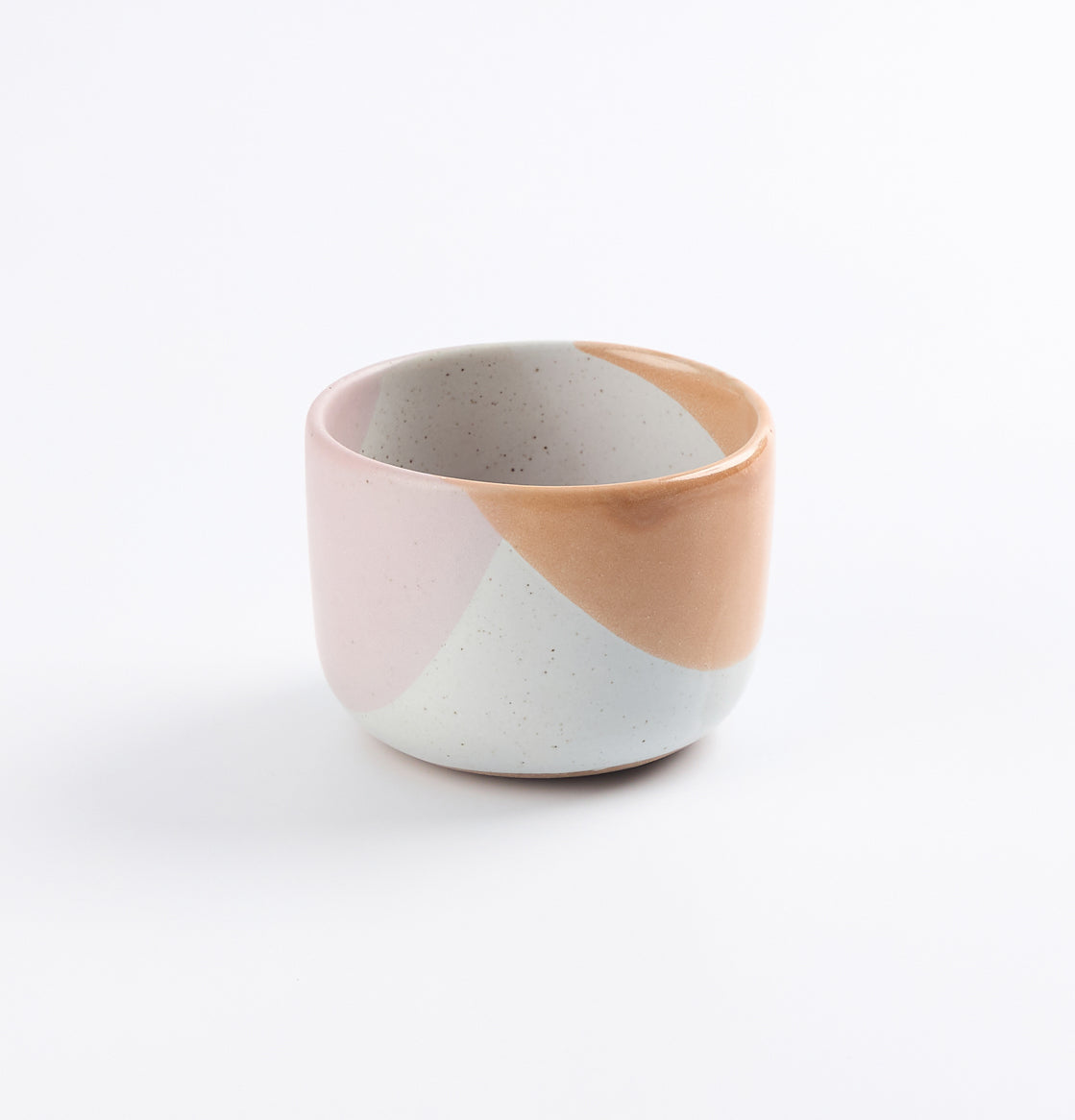 Handmade ceramic tumbler cup with two-tone design on a white background
