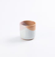 Ceramic cup with two-tone design on a white background