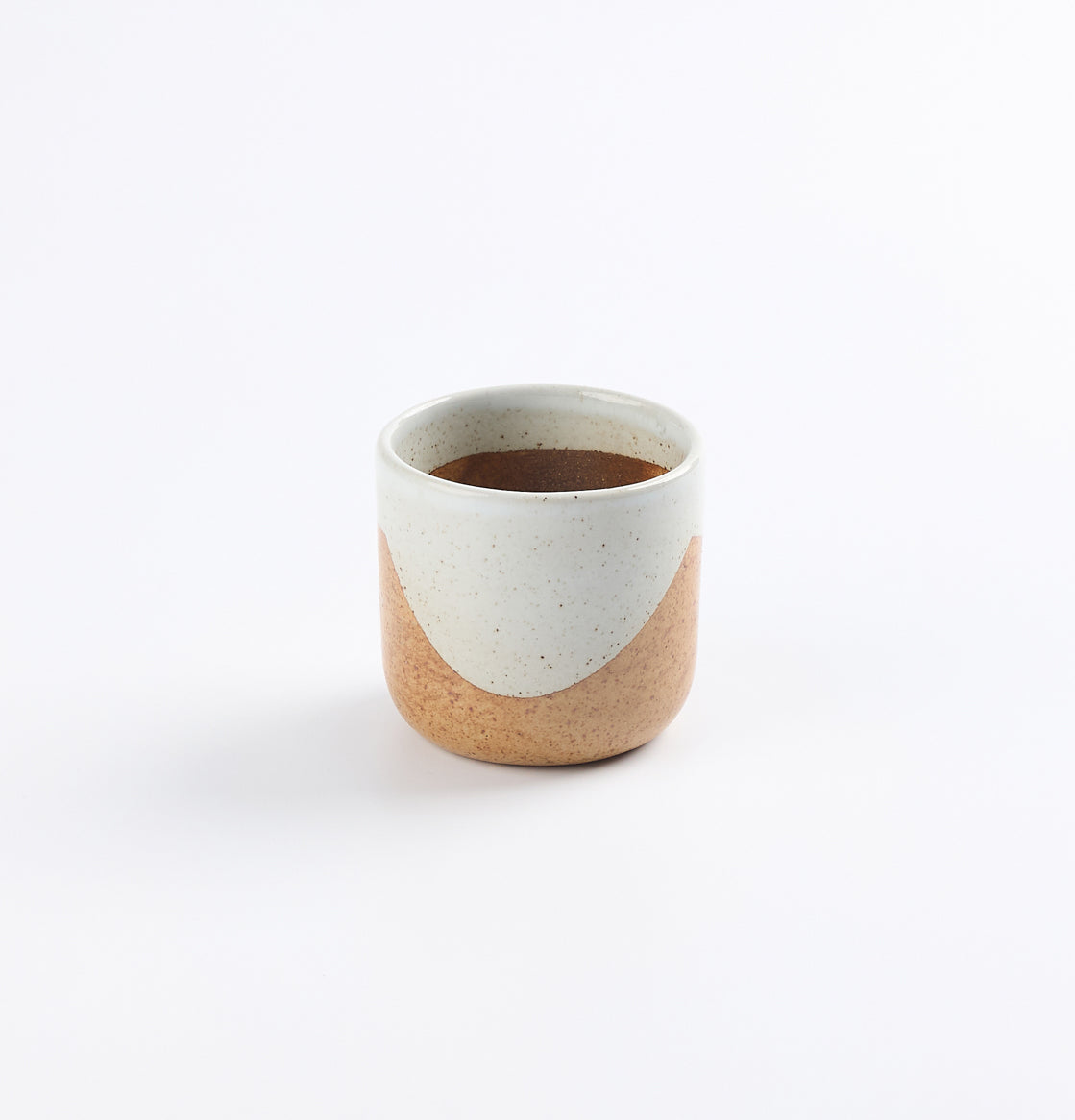 Ceramic stoneware cup with two-tone soda fired in blue and brown design on a white background