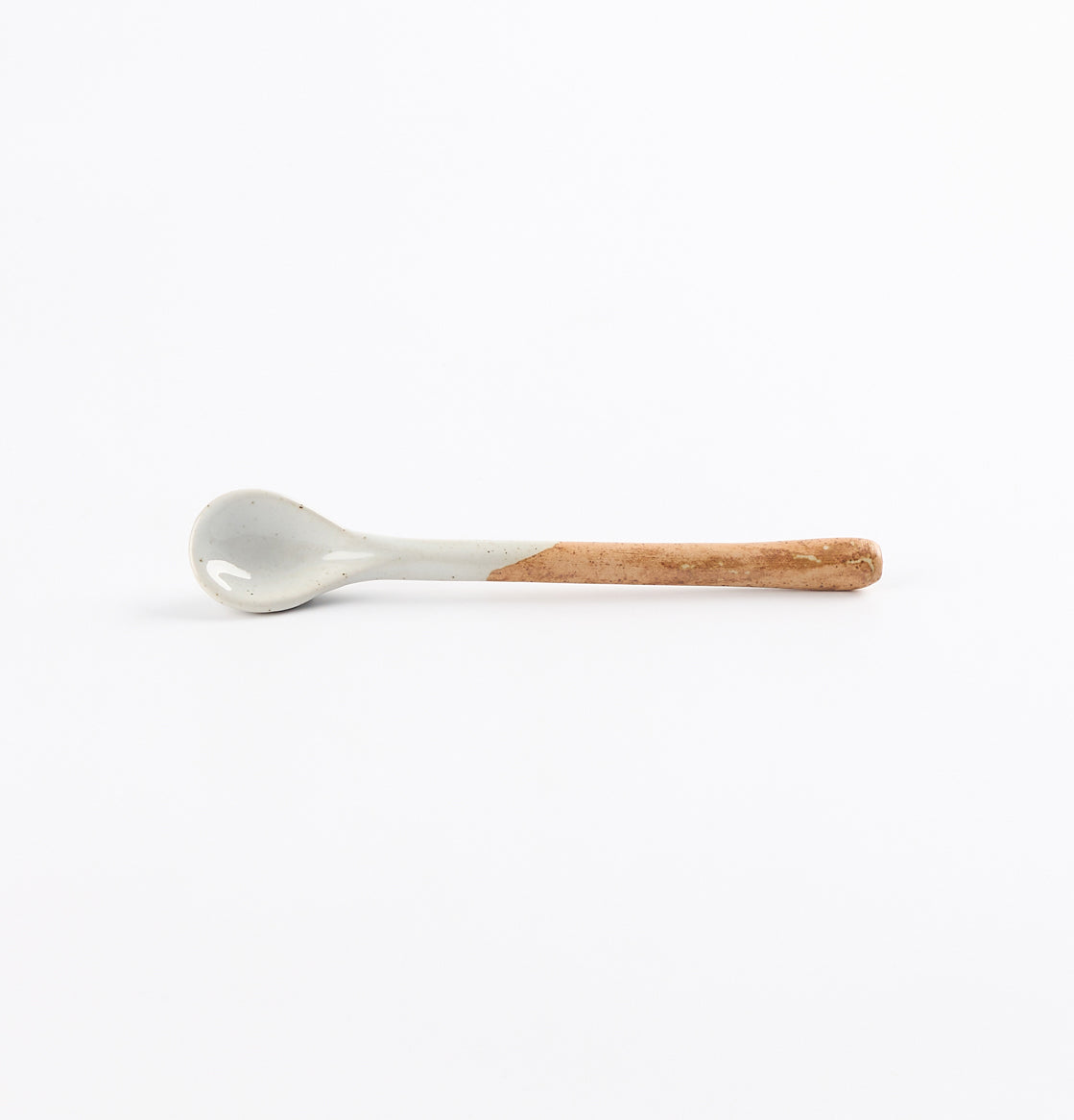 Ceramic teaspoon with two tone blue and brown colours on a white background