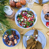 Bright summer table with fresh salads, hand made ceramics in blue and white, pottery dinner sets for Christmas 