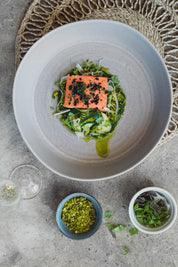 Handmade stoneware fruit bowl in a neutral mushroom grey plated up by Sydney chef Gerald Touchard with salmon and veggies