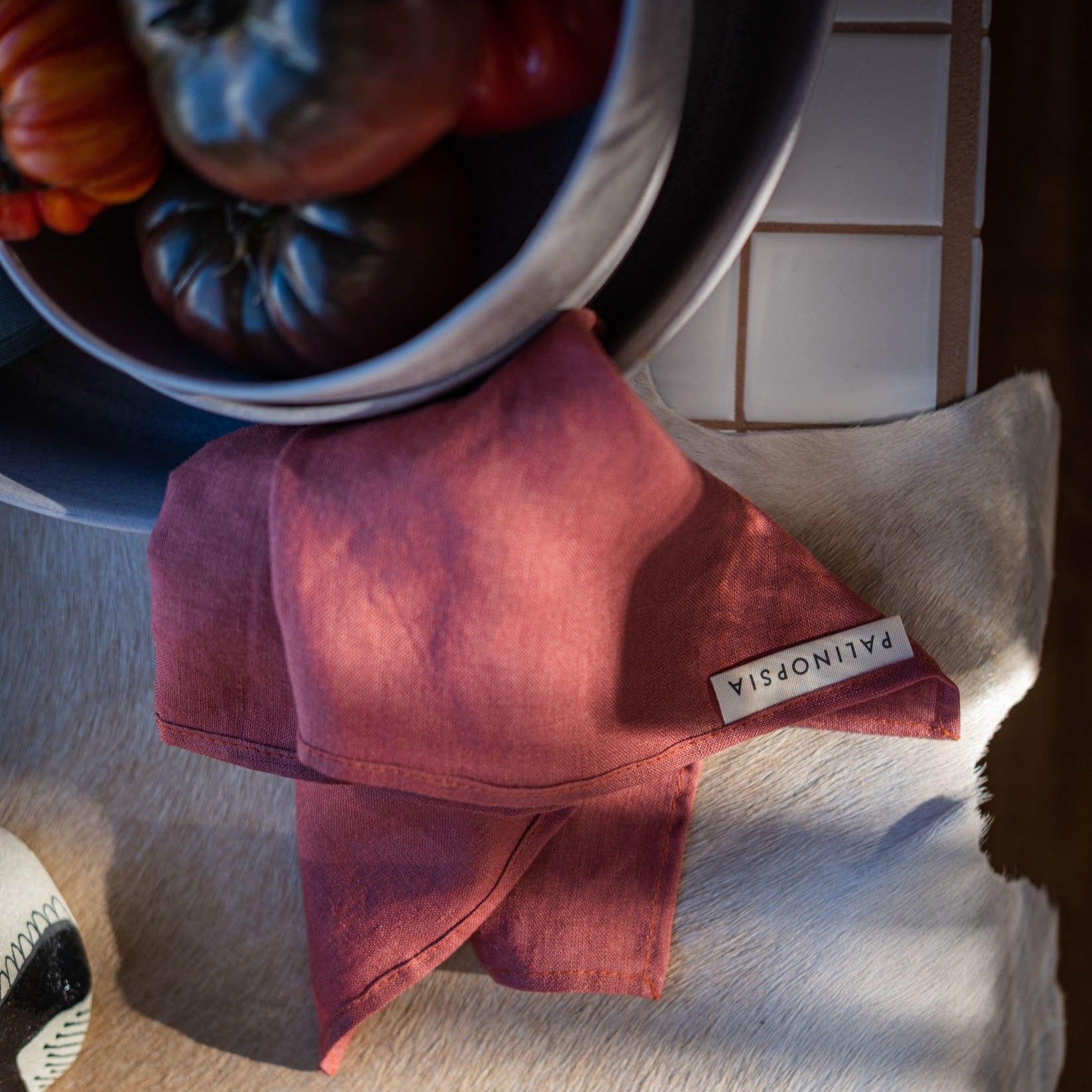 Terracotta pure linen napkin with ripe red tomatoes 