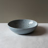 Side view of Palinopsia's handmade breakfast bowl in blue speckle  