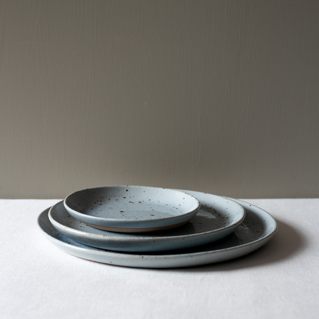 3 piece dinner set on a white tablecloth 