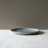 Side view of Palinopsia's Handmade blue speckle lunch plate 