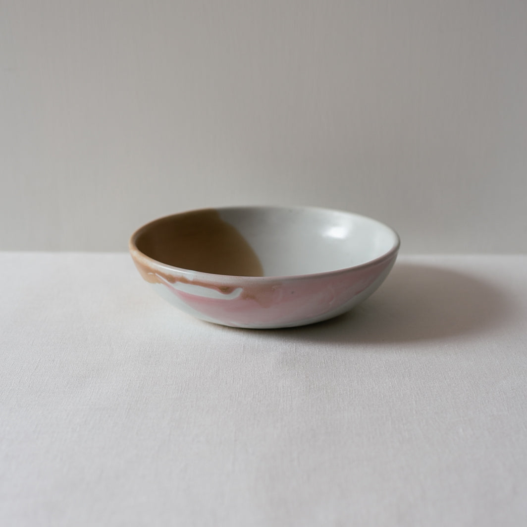 Side view of a colourful pink and brown breakfast bowl  