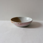 Side view of a colourful pink and brown breakfast bowl  