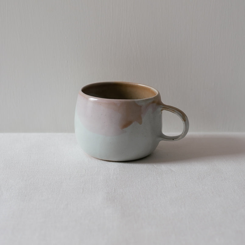 Single handmade mug in colourful drippy glaze 