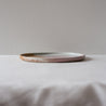 Handmade dinner plate with contemporary raised lip, detailed photo showing drippy glaze