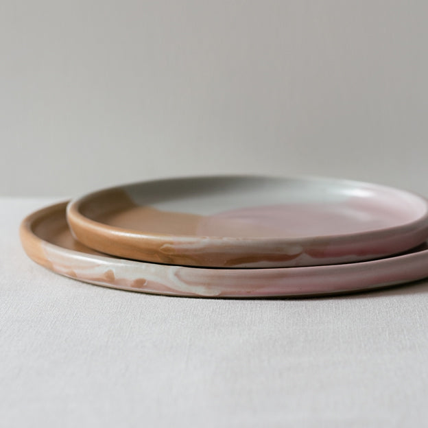 Closeup of a handmade plate by Palinopsia Ceramics in pinks, brown and white