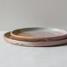 Handmade stacked plates by Palinopsia Ceramics, stoneware in pink, brown and white  