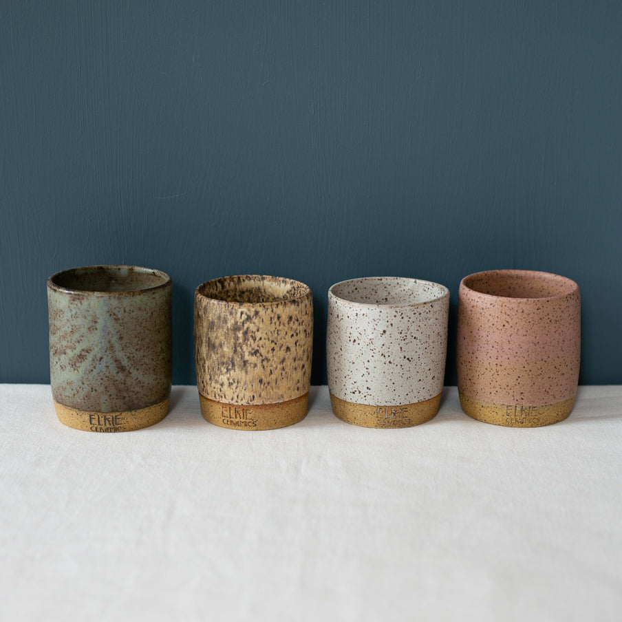 Assorted Coffee cups and mugs in speckled clay and glazes by Australian Ceramist Elkie Fairbrother, green, blue white and pink 