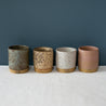 Assorted Coffee cups and mugs in speckled clay and glazes by Australian Ceramist Elkie Fairbrother, green, blue white and pink 