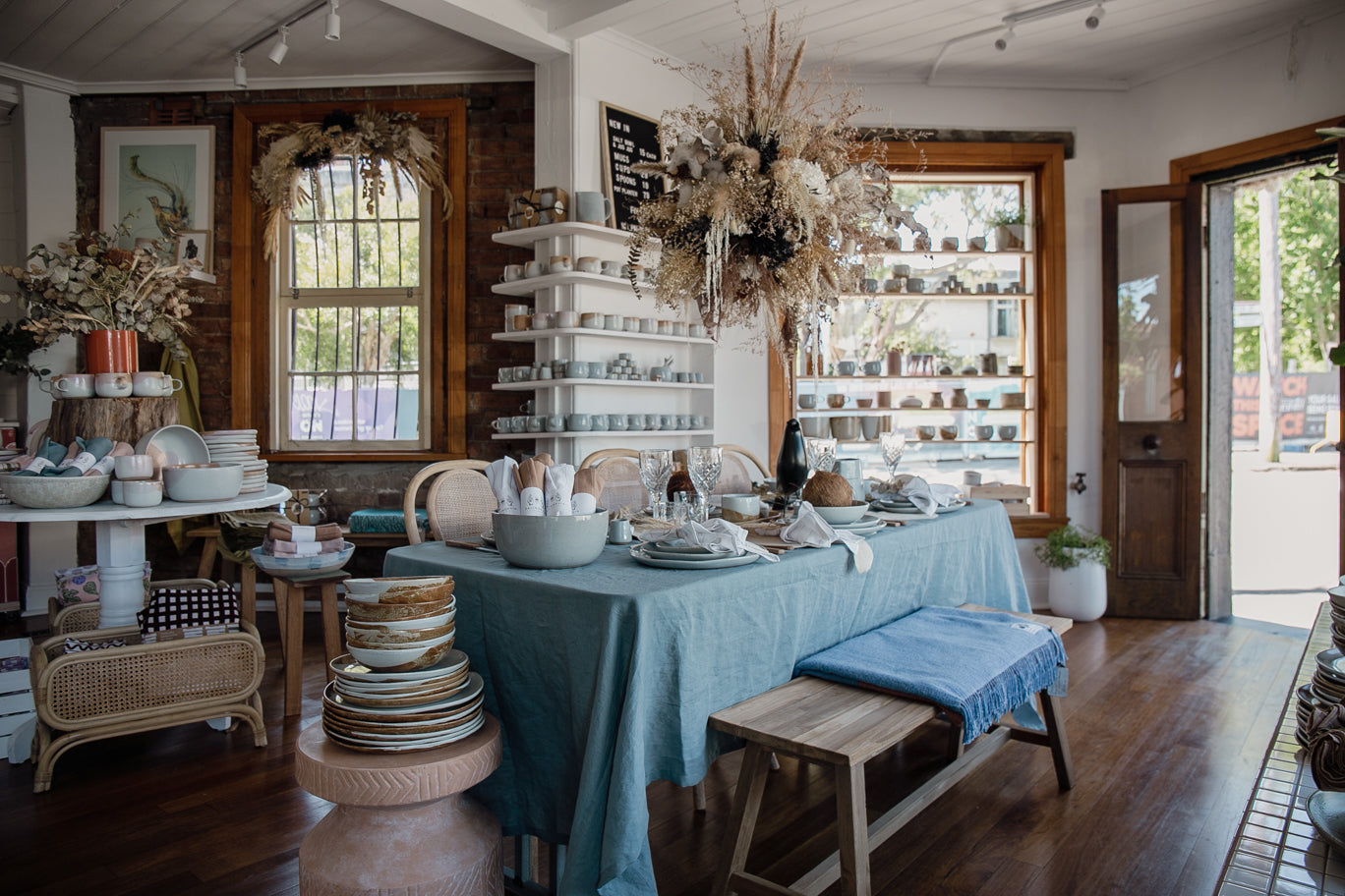 Dining table set with handade ceramics by Palinopsia and Australian made pure linen collection in blues and greys