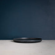 Side view of a Handmade Black dinner plate made with reactive glaze by Palinopsia Ceramics in Sydney Australia  