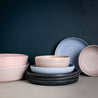 Handmade dinner set by Palinopsia Ceramics in block colours of pink, mushroom grey, blue and black dinner plates